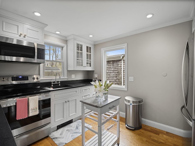 17 Edwards Rd, Hyannis, MA 02601 - kitchen featuring white cabinets, appliances with stainless steel finishes, ornamental molding, and a sink