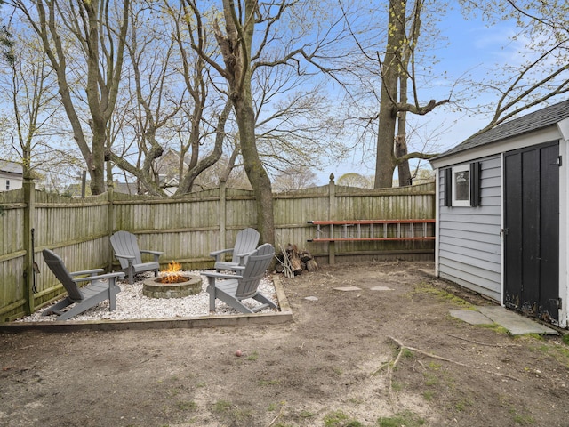 17 Edwards Rd, Hyannis, MA 02601 - view of patio featuring a fenced backyard, a storage unit, an outdoor structure, and an outdoor fire pit
