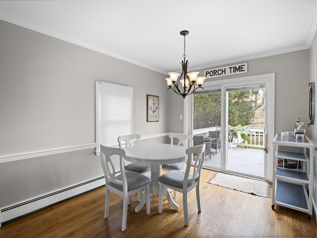 17 Edwards Rd, Hyannis, MA 02601 - dining space with crown molding, a baseboard heating unit, wood finished floors, and a chandelier
