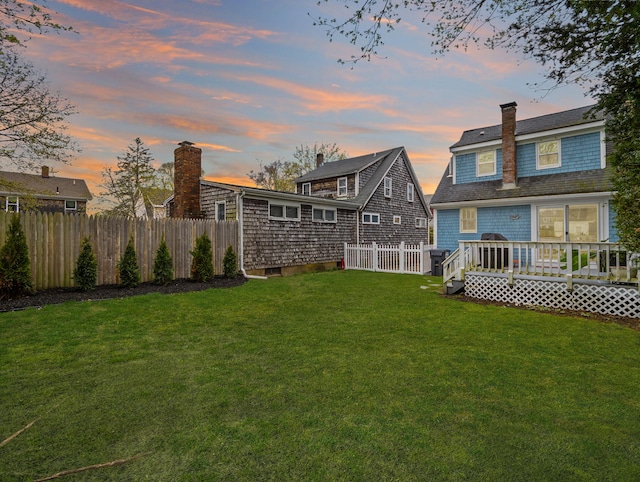 17 Edwards Rd, Hyannis, MA 02601 - back of house featuring an outdoor structure, fence, a wooden deck, a chimney, and a yard
