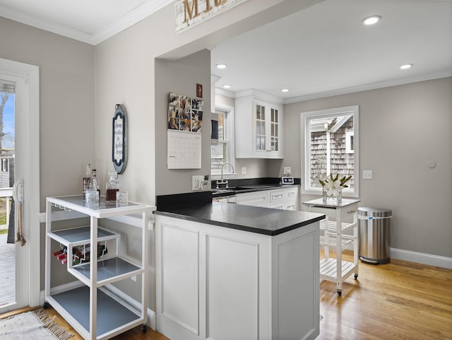 17 Edwards Rd, Hyannis, MA 02601 - kitchen with ornamental molding, a sink, a healthy amount of sunlight, and dark countertops