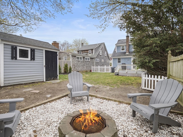 17 Edwards Rd, Hyannis, MA 02601 - view of yard featuring a storage shed, fence, an outdoor structure, and an outdoor fire pit