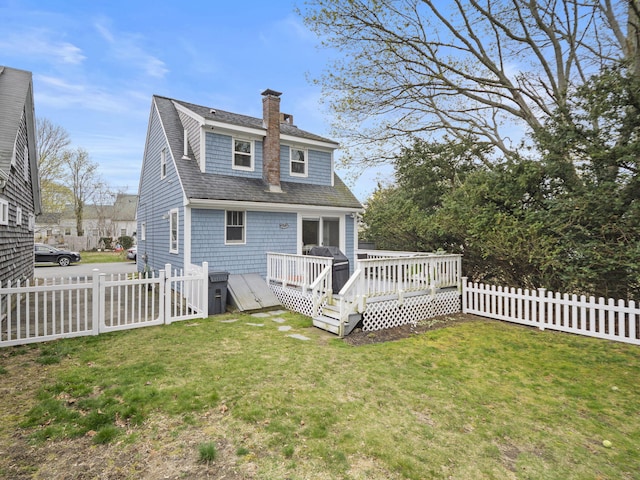 17 Edwards Rd, Hyannis, MA 02601 - rear view of house featuring a shingled roof, a deck, a chimney, a yard, and fence private yard