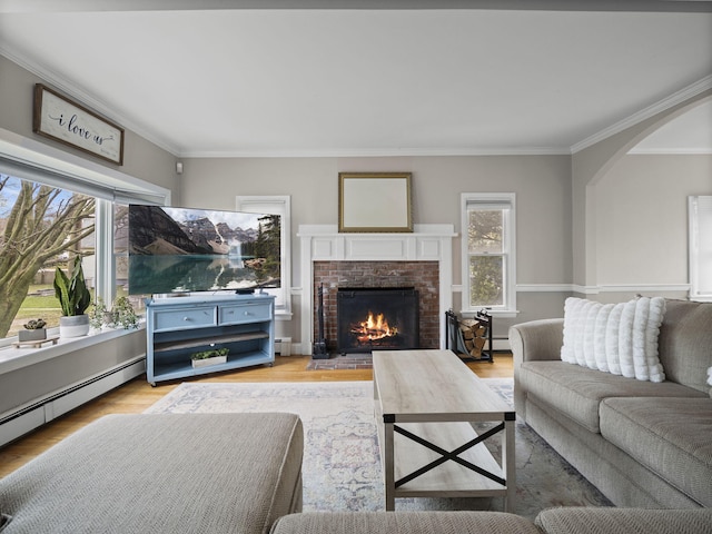 17 Edwards Rd, Hyannis, MA 02601 - living area featuring crown molding, light wood-style flooring, a wealth of natural light, and a fireplace