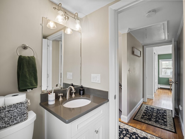 17 Edwards Rd, Hyannis, MA 02601 - half bath featuring baseboard heating, wood finished floors, vanity, baseboards, and toilet