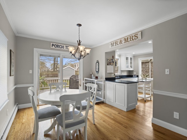 17 Edwards Rd, Hyannis, MA 02601 - dining area with an inviting chandelier, light wood-style floors, ornamental molding, and baseboard heating