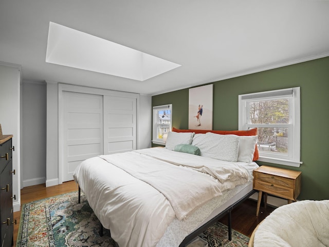 17 Edwards Rd, Hyannis, MA 02601 - bedroom with baseboards, crown molding, wood finished floors, and a skylight