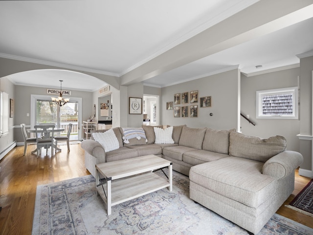 17 Edwards Rd, Hyannis, MA 02601 - living area featuring an inviting chandelier, arched walkways, wood finished floors, and ornamental molding