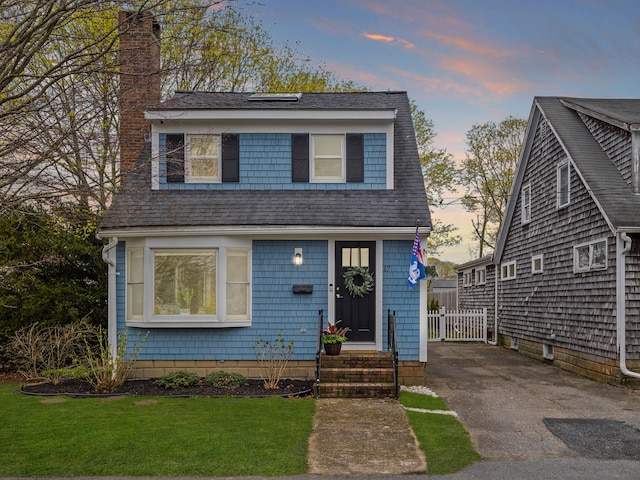 17 Edwards Rd, Hyannis, MA 02601 - view of front of home featuring roof with shingles, a chimney, and a front lawn