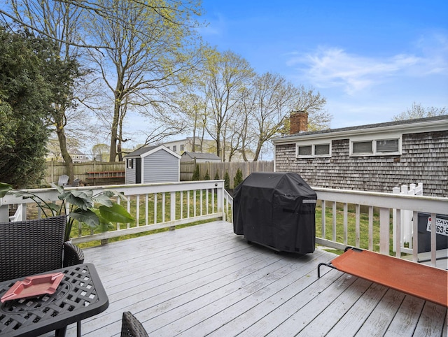 17 Edwards Rd, Hyannis, MA 02601 - deck with a fenced backyard, an outbuilding, a grill, and a shed