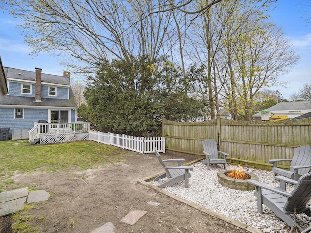 17 Edwards Rd, Hyannis, MA 02601 - view of yard featuring a fenced backyard, a fire pit, and a deck