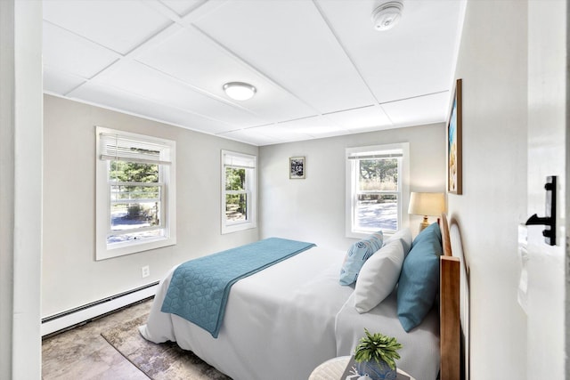 bedroom with a baseboard radiator and a drop ceiling