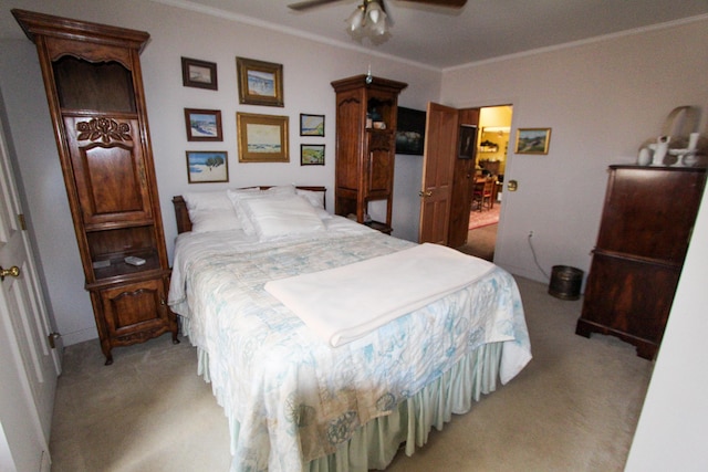 bedroom featuring ceiling fan, light colored carpet, and ornamental molding