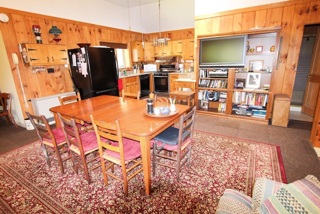 dining room with wood walls and a high ceiling