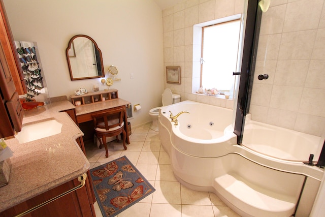 bathroom with toilet, a bath, vanity, and tile patterned flooring