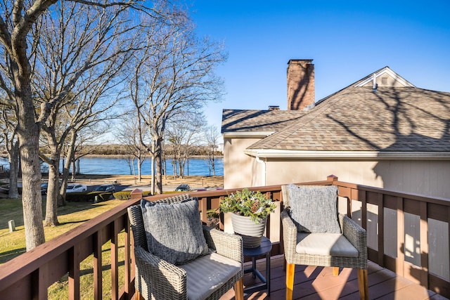 wooden deck featuring a water view