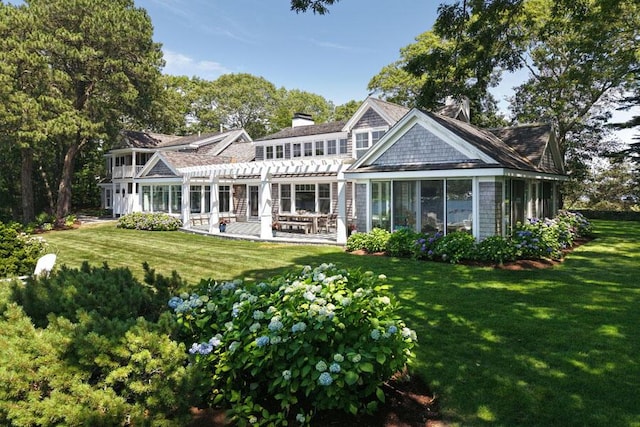 71 Sand Pt, Osterville, MA 02655 - back of house with a pergola, a chimney, a lawn, and a patio