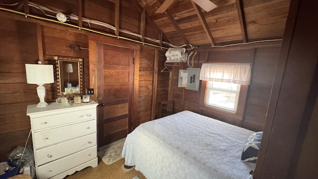 bedroom featuring electric panel, wood walls, and lofted ceiling