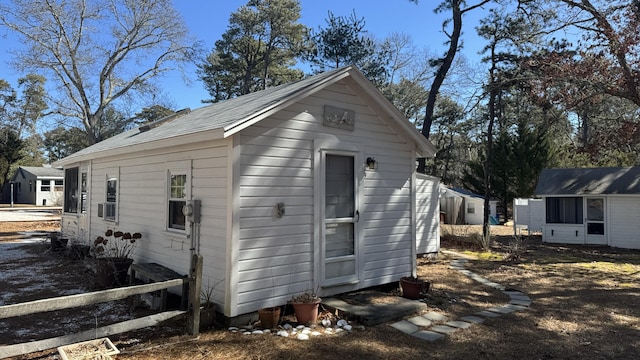 view of side of property featuring an outbuilding