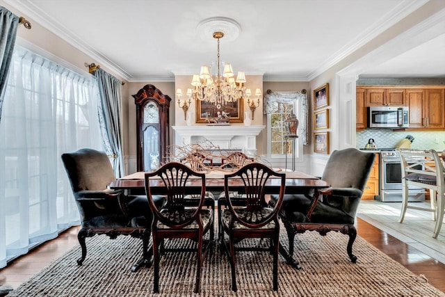 13 Old Colony Way, Provincetown, MA 02657 - dining space featuring a chandelier, plenty of natural light, light wood-style floors, ornamental molding, and wainscoting