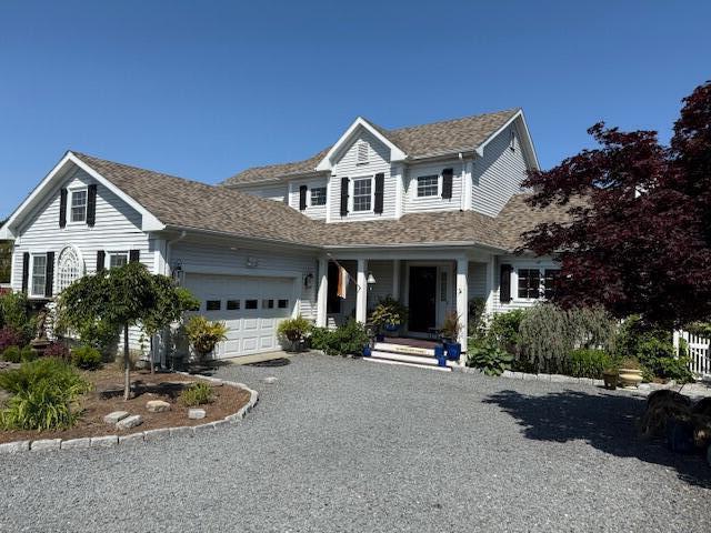 13 Old Colony Way, Provincetown, MA 02657 - traditional-style house featuring an attached garage, covered porch, driveway, and roof with shingles