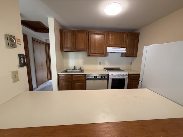 281 Orleans Rd Unit 5, North Chatham, MA 02650 - kitchen featuring white appliances, under cabinet range hood, light countertops, and brown cabinetry