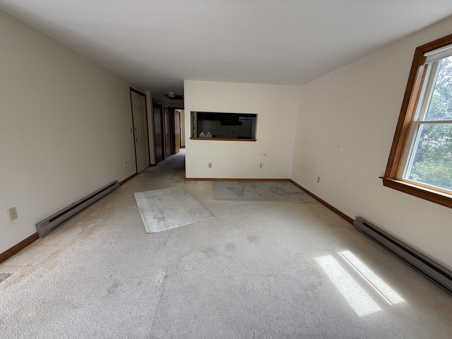 281 Orleans Rd Unit 5, North Chatham, MA 02650 - unfurnished living room with a baseboard heating unit, plenty of natural light, and carpet