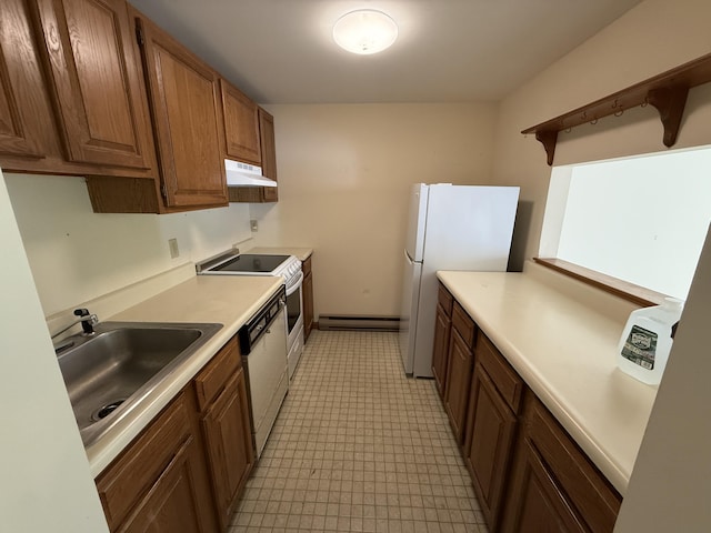 281 Orleans Rd Unit 5, North Chatham, MA 02650 - kitchen with under cabinet range hood, baseboard heating, white appliances, and light countertops