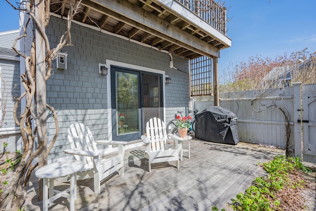 view of patio / terrace featuring fence, a balcony, and a grill