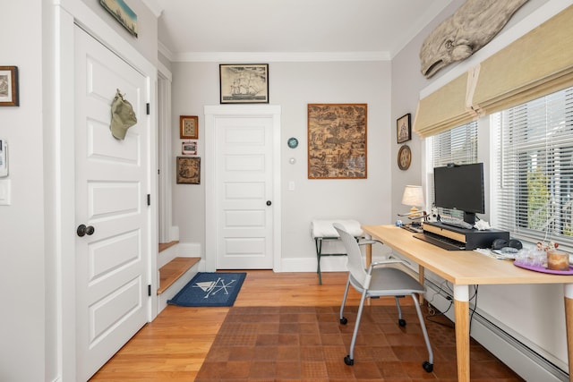 office space featuring crown molding, baseboards, and light wood finished floors
