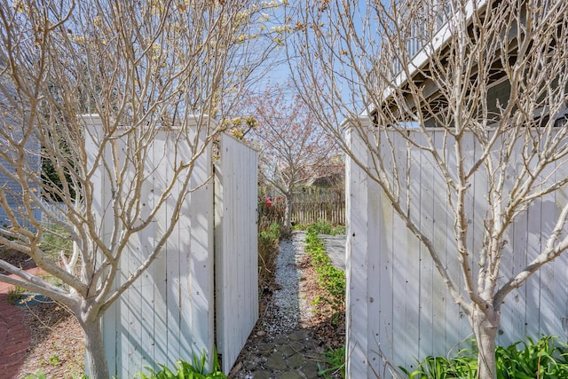 view of side of home featuring fence