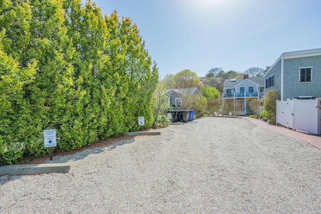 view of street featuring driveway and a gate