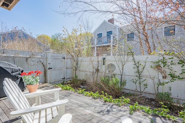 view of patio with a wooden deck, a gate, and a fenced backyard