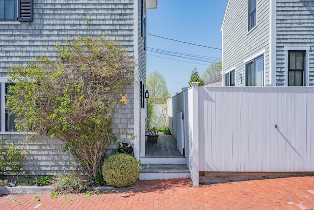 view of side of property featuring fence
