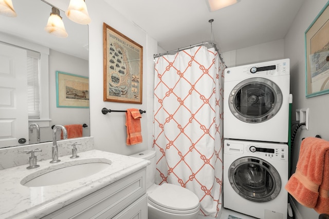 bathroom featuring stacked washer and dryer, toilet, a shower with shower curtain, and vanity