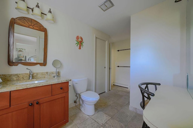 bathroom featuring baseboard heating, toilet, and vanity