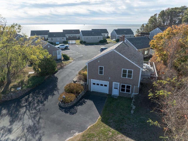 birds eye view of property with a water view