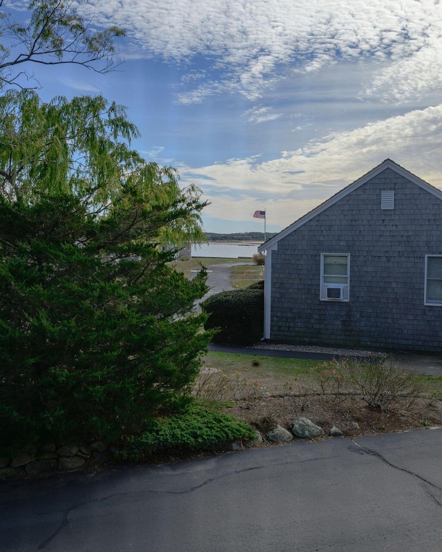 view of property exterior featuring a water view