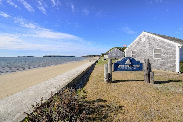 view of community with a water view and a beach view