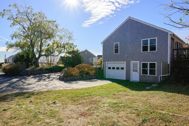 view of home's exterior with a yard and a garage