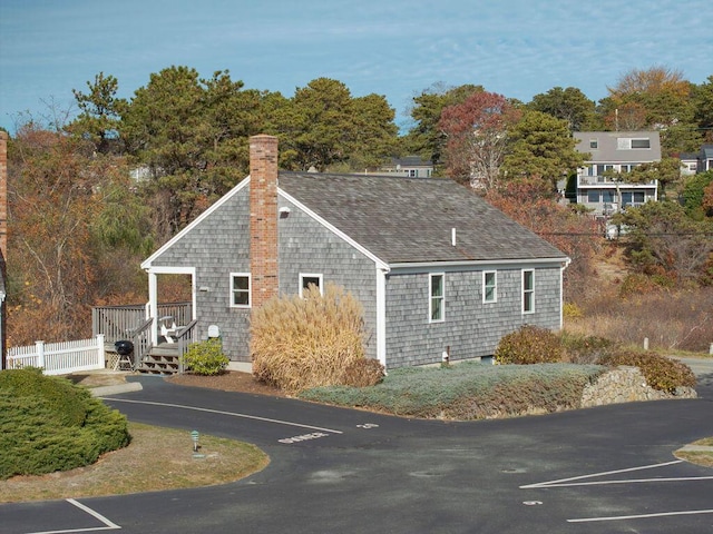 view of property exterior featuring a wooden deck