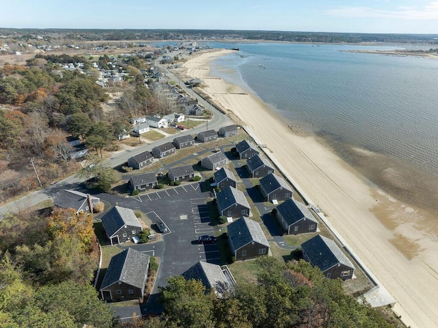 aerial view with a water view and a beach view