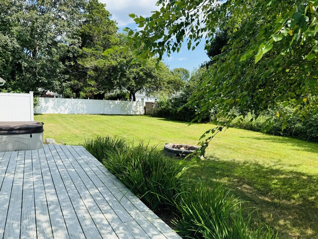 view of yard with an outdoor fire pit and a wooden deck