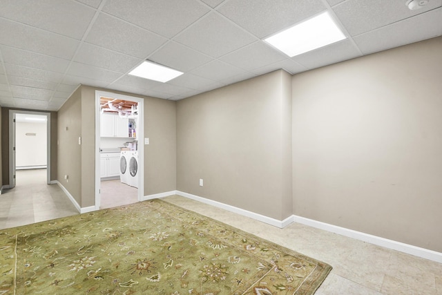 interior space featuring a paneled ceiling and separate washer and dryer