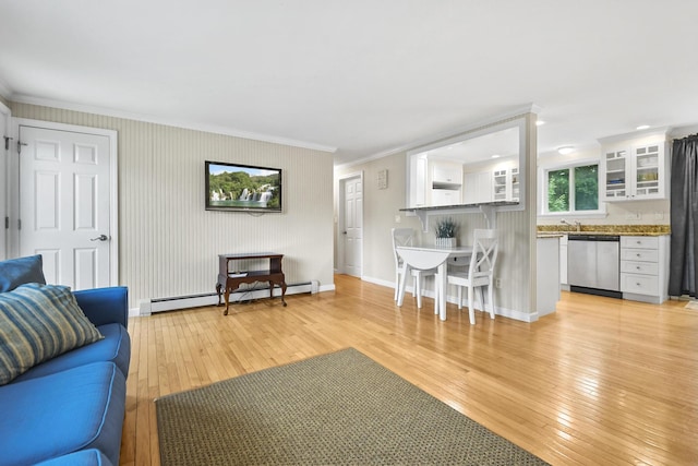 living room with light hardwood / wood-style floors, ornamental molding, and a baseboard radiator