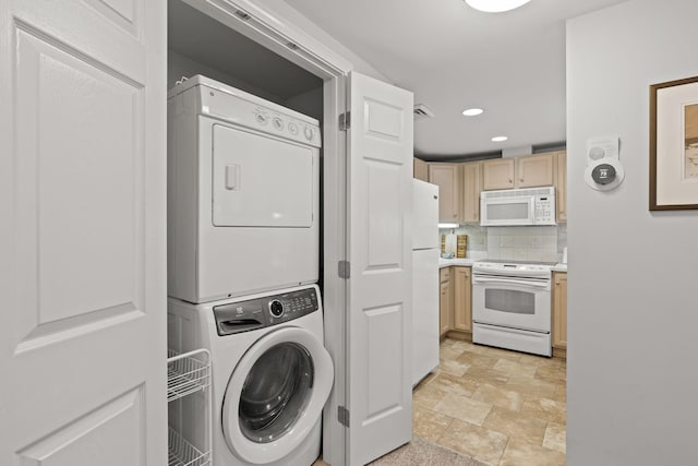 18 W Rd Unit 315, Orleans, MA 02653 - laundry room featuring stacked washing machine and dryer, stone finish floors, and recessed lighting