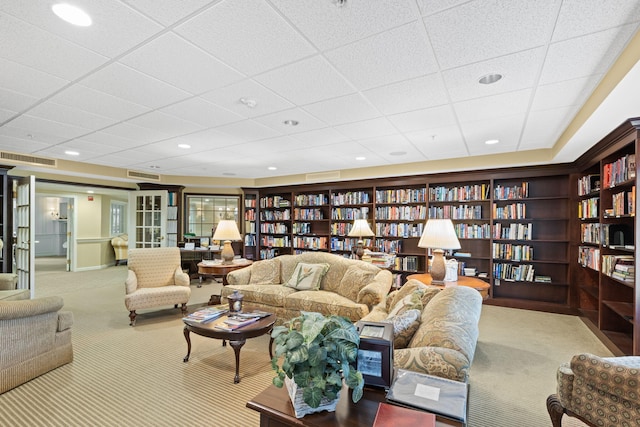18 W Rd Unit 315, Orleans, MA 02653 - living room with wall of books, carpet, and a paneled ceiling
