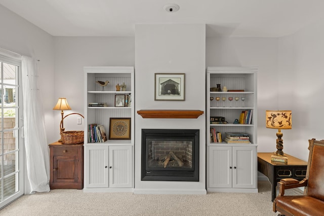 18 W Rd Unit 315, Orleans, MA 02653 - carpeted living room featuring a glass covered fireplace and built in features