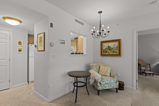 18 W Rd Unit 315, Orleans, MA 02653 - living area featuring light colored carpet, a chandelier, and baseboards