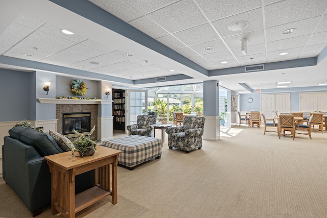 18 W Rd Unit 315, Orleans, MA 02653 - carpeted living room with a drop ceiling, a fireplace, and wainscoting